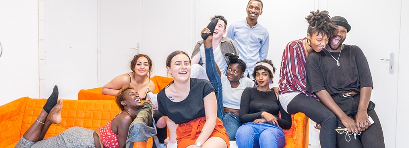 Photo of young people on an orange couch